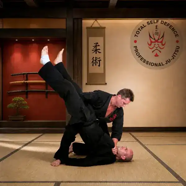 Ju-Jitsu ground throw demonstrated by black-belt instructors