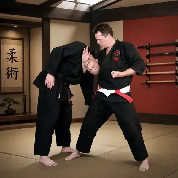 Total Self Defence instructor demonstrating a controlled standing Ju-Jitsu wrist lock
